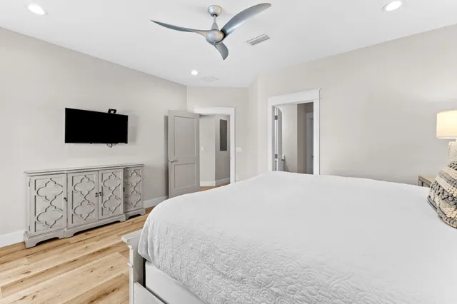 a bedroom with a bed and a ceiling fan