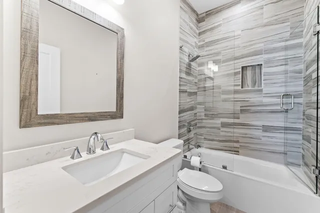 a bedroom with a large bed and a ceiling fan