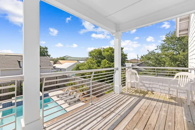 a view of a balcony with floor to ceiling windows with wooden floor
