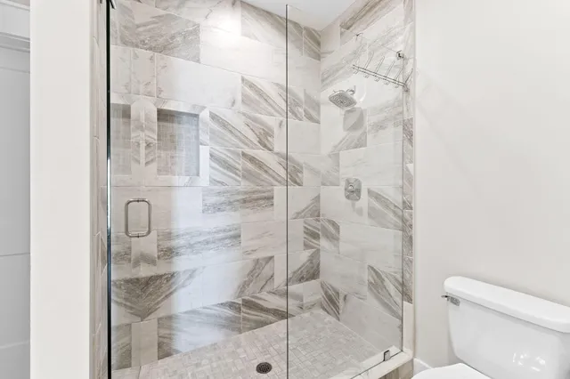 an aerial view of a house with a garden and lake view