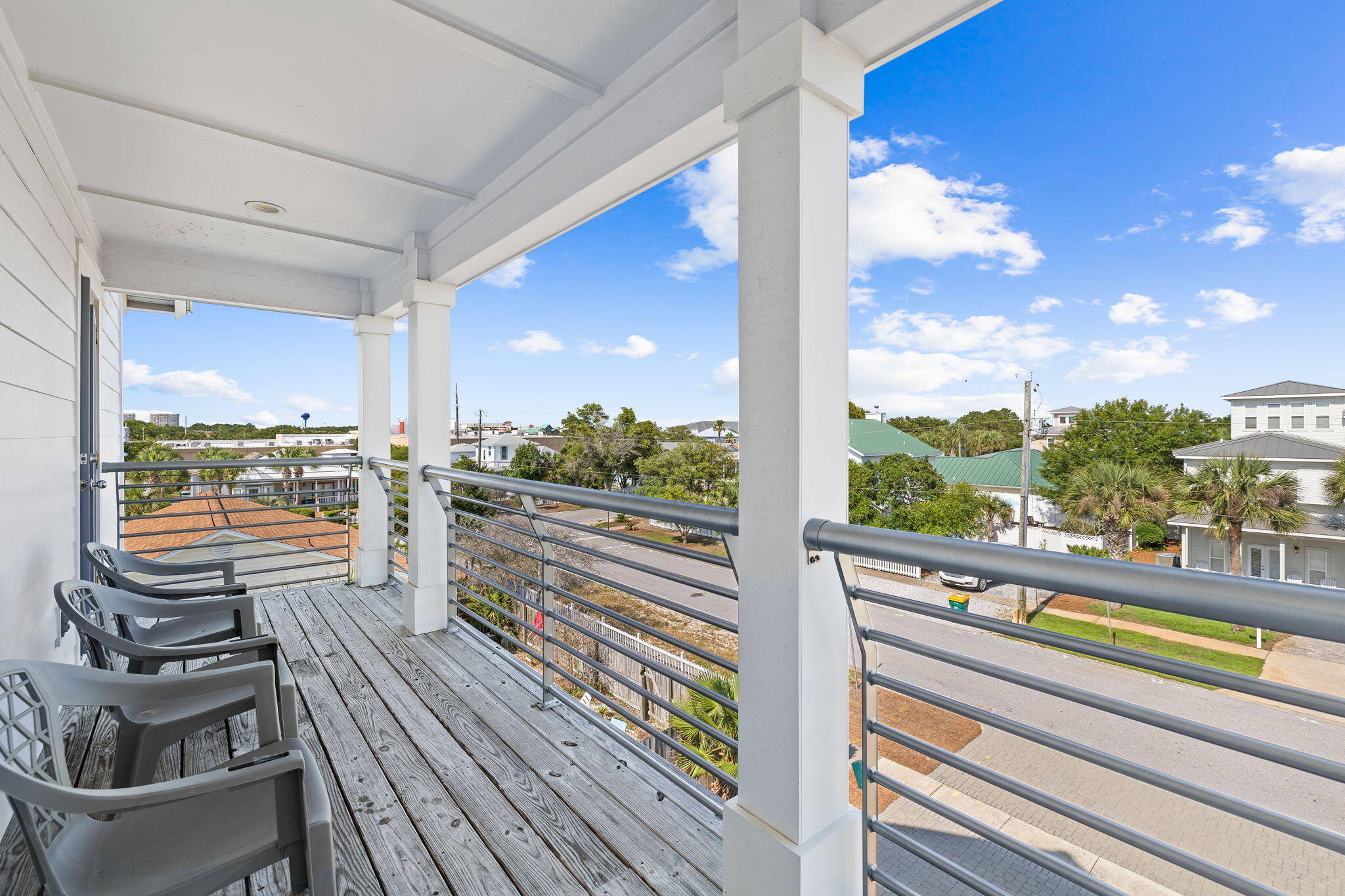 106 Shirah Street Destin, FL 32541 - Photo 58 of 91 a view of a balcony with floor to ceiling windows with wooden floor