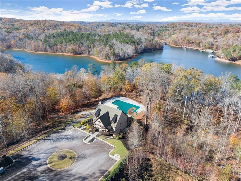 6415 Tranquillity Manor Road Dawsonville, GA 30534 - Photo 20 of 25 a view of a lake with a mountain in the background