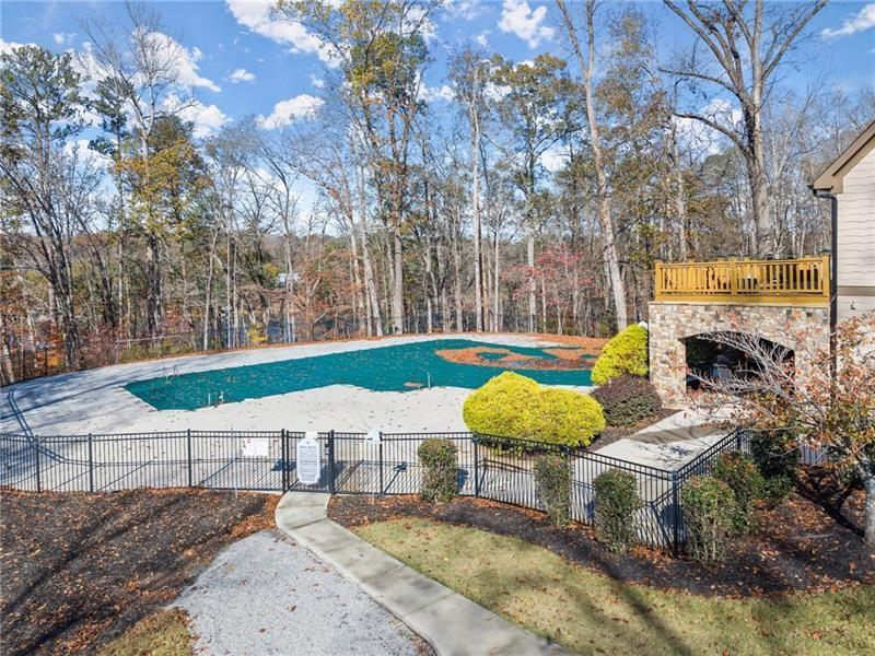 6415 Tranquillity Manor Road Dawsonville, GA 30534 - Photo 4 of 25 a view of a chairs and table in the backyard