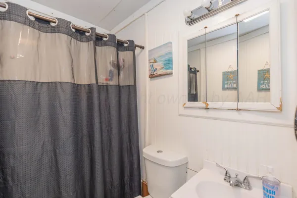 a bathroom with a shower curtain and a sink
