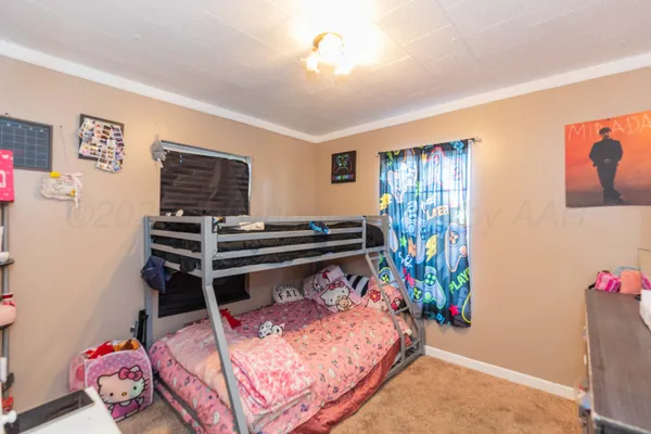 a bedroom with furniture and a window