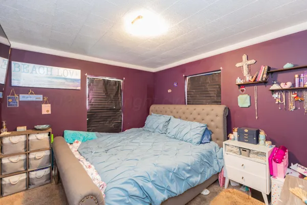 a bedroom with a bed and dresser