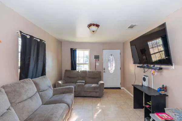 a living room with furniture and a flat screen tv