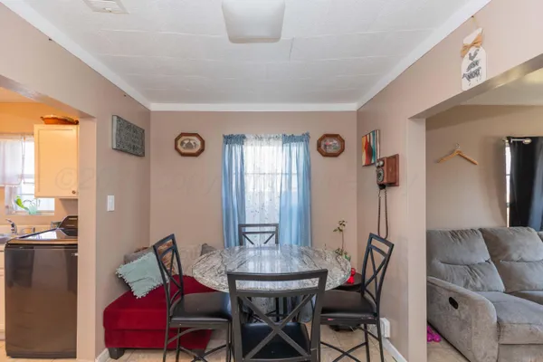 a view of a dining room with furniture and window