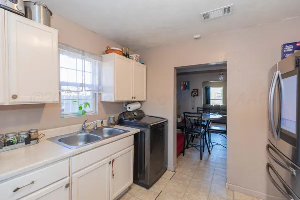 a kitchen with a sink cabinets and appliances