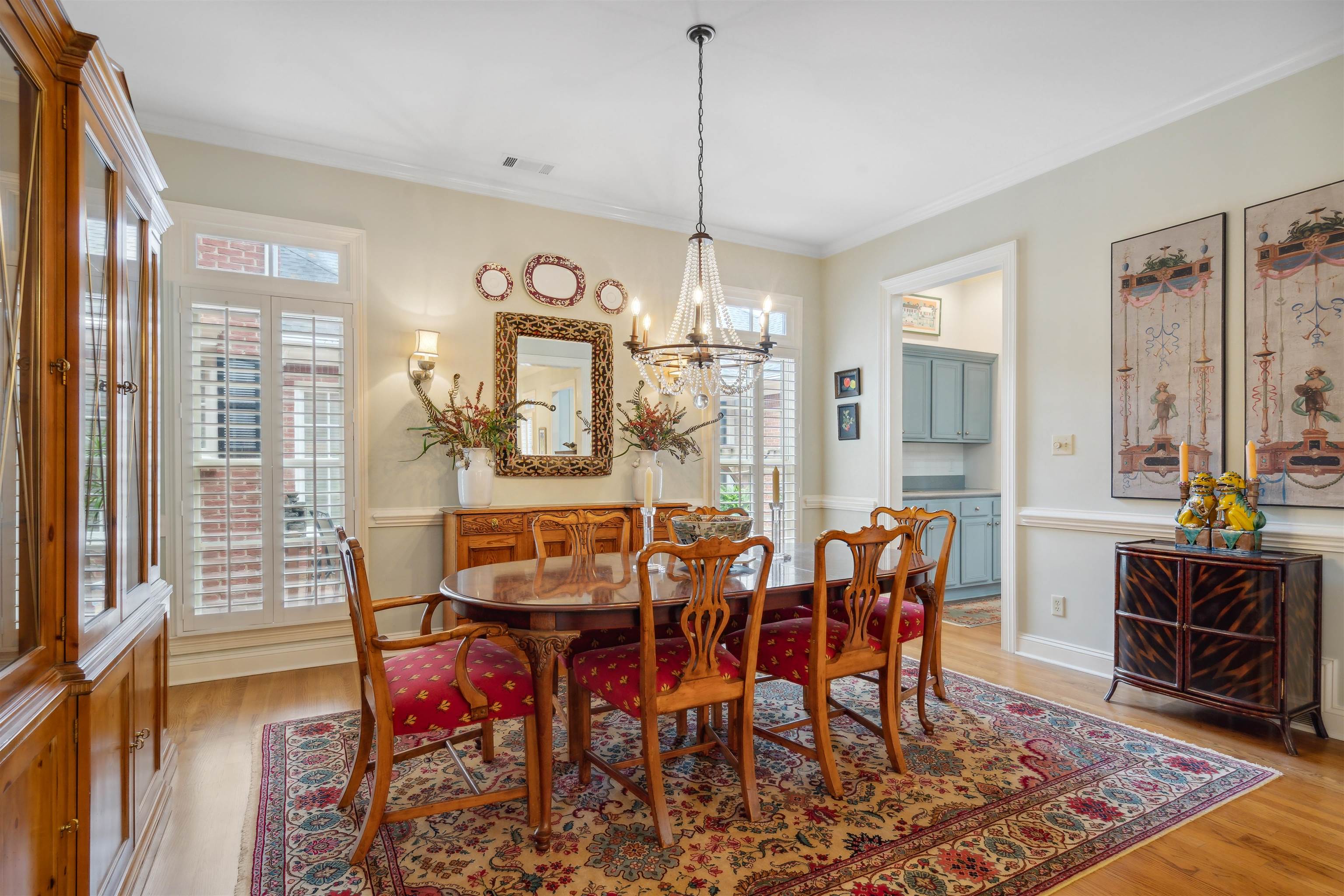 3536 Walnut Grove Road Memphis, TN 38111 - Photo 7 of 18 a dining room with furniture a chandelier and wooden floor