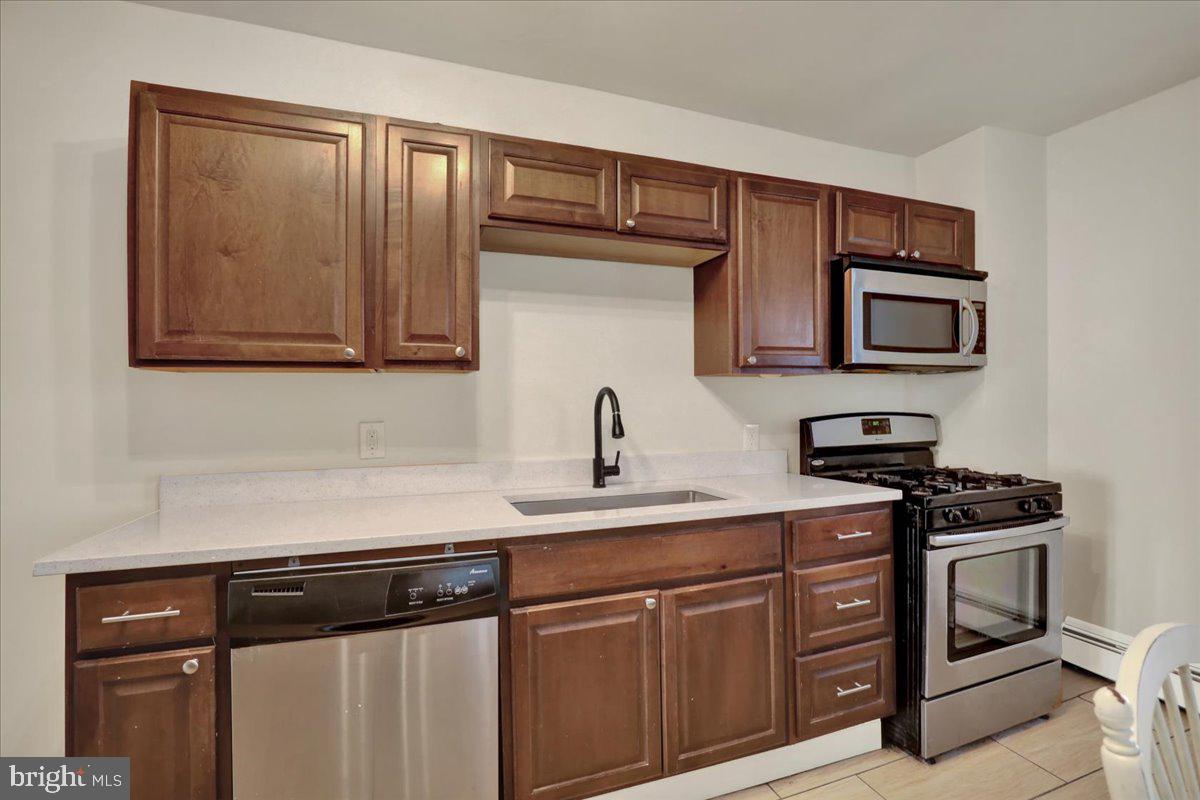 623 Bay Street Lancaster, PA 17603 - Photo 9 of 23 a kitchen with stainless steel appliances granite countertop a sink stove and microwave