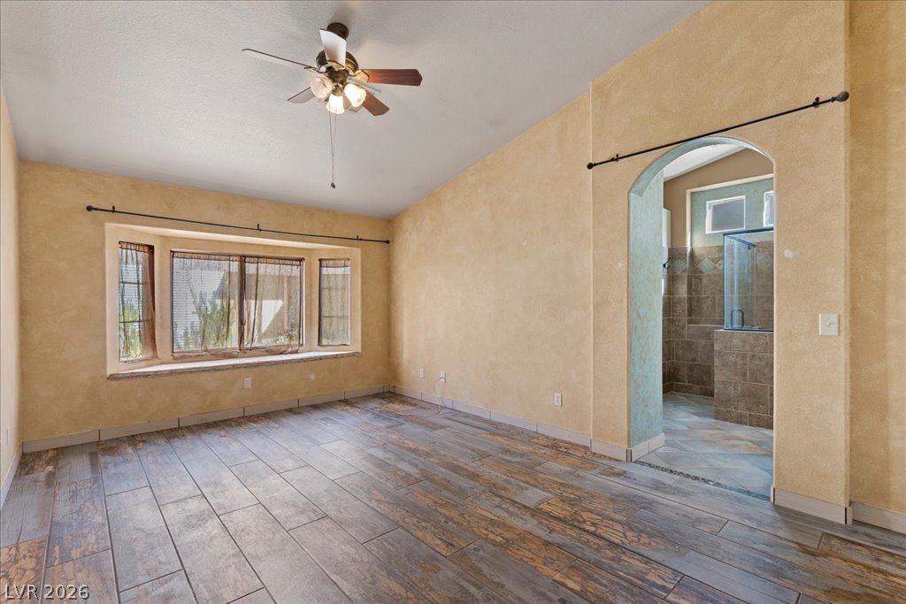 120 Ringlore Road Henderson, NV 89015 - Photo 19 of 58 Wood-look tile flooring and a wide bay window frame this versatile primary suite.