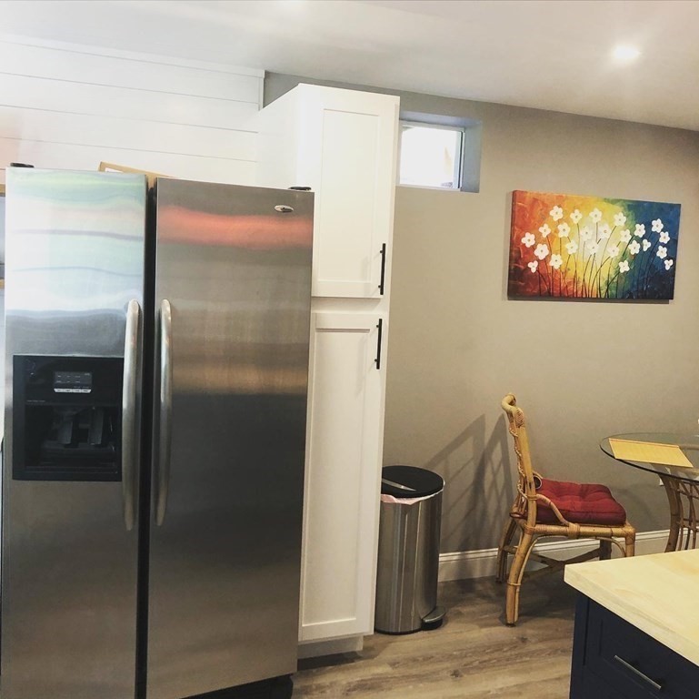 1 Park Road, Unit 1 Sandwich, MA 02644 - Photo 8 of 25 a room with a refrigerator and wooden floor