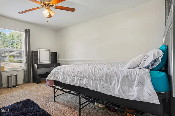 a bathroom with a sink a toilet and shower curtain