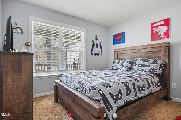 a bed room with a bed and a chair