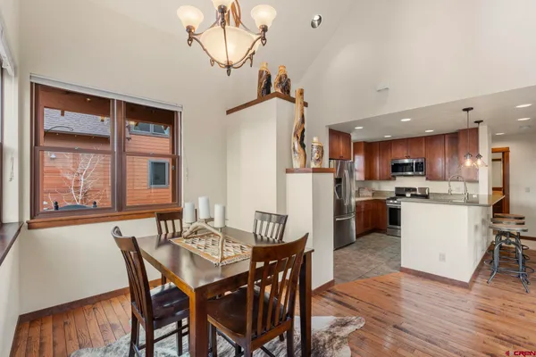 a view of a dining room with furniture window and wooden floor