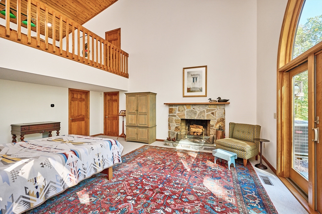 72 Crooked Ledge Road Southampton, MA 01073 - Photo 18 of 42 a bedroom with a bed and a fireplace