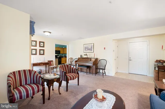 a living room with furniture and a dining table