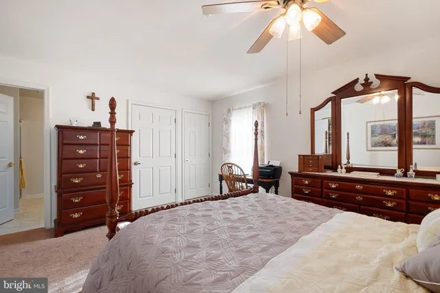 a bedroom with a bed and a large mirror