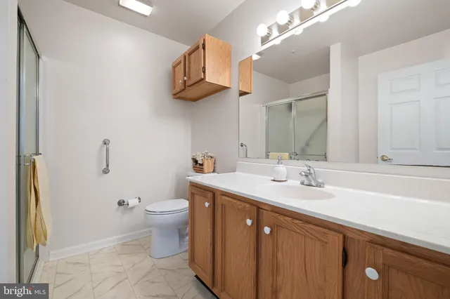 a bathroom with a toilet a sink and mirror