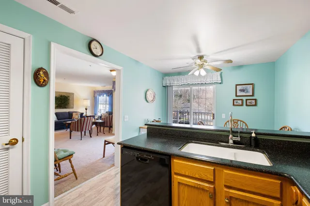 a kitchen with a sink cabinets and window