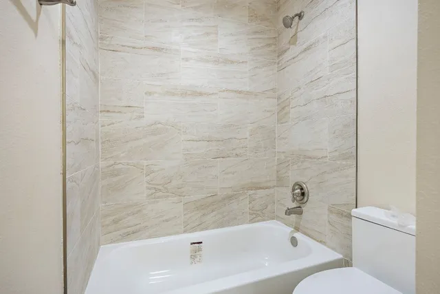 a bathroom with a bathtub and a toilet