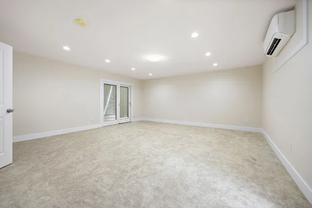 an empty room with windows and pillars in it