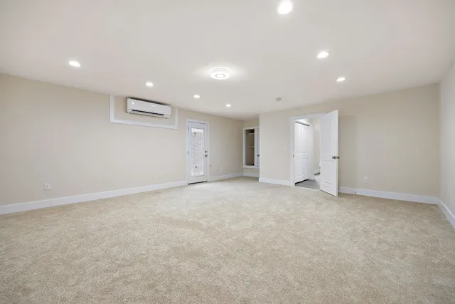 an empty room with closet and windows