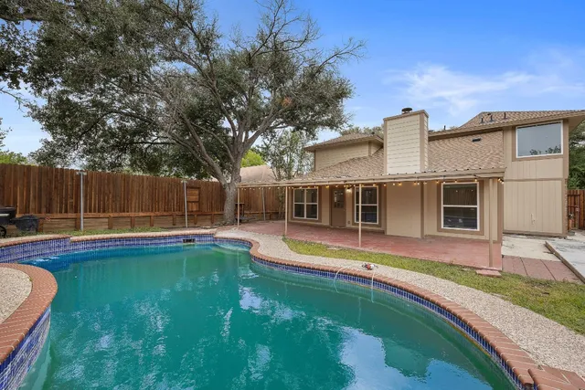 a view of a house with swimming pool and a yard