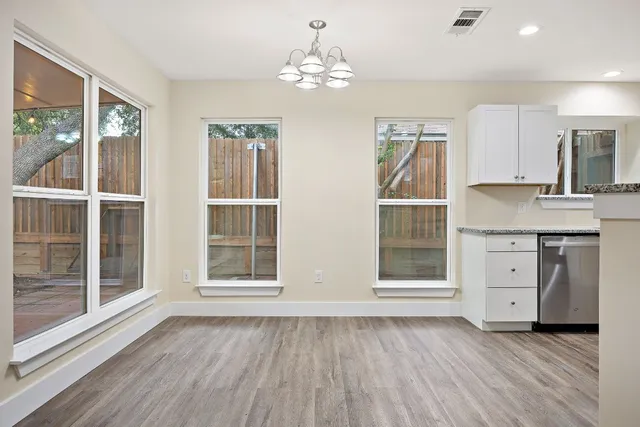 a view of a kitchen with cabinets and wooden floor