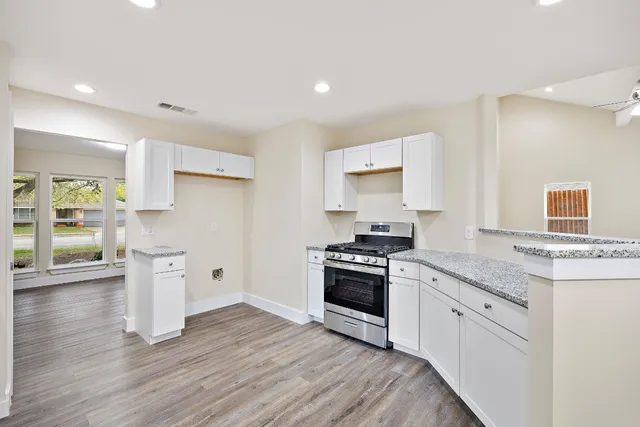 a kitchen with a stove top oven sink and refrigerator