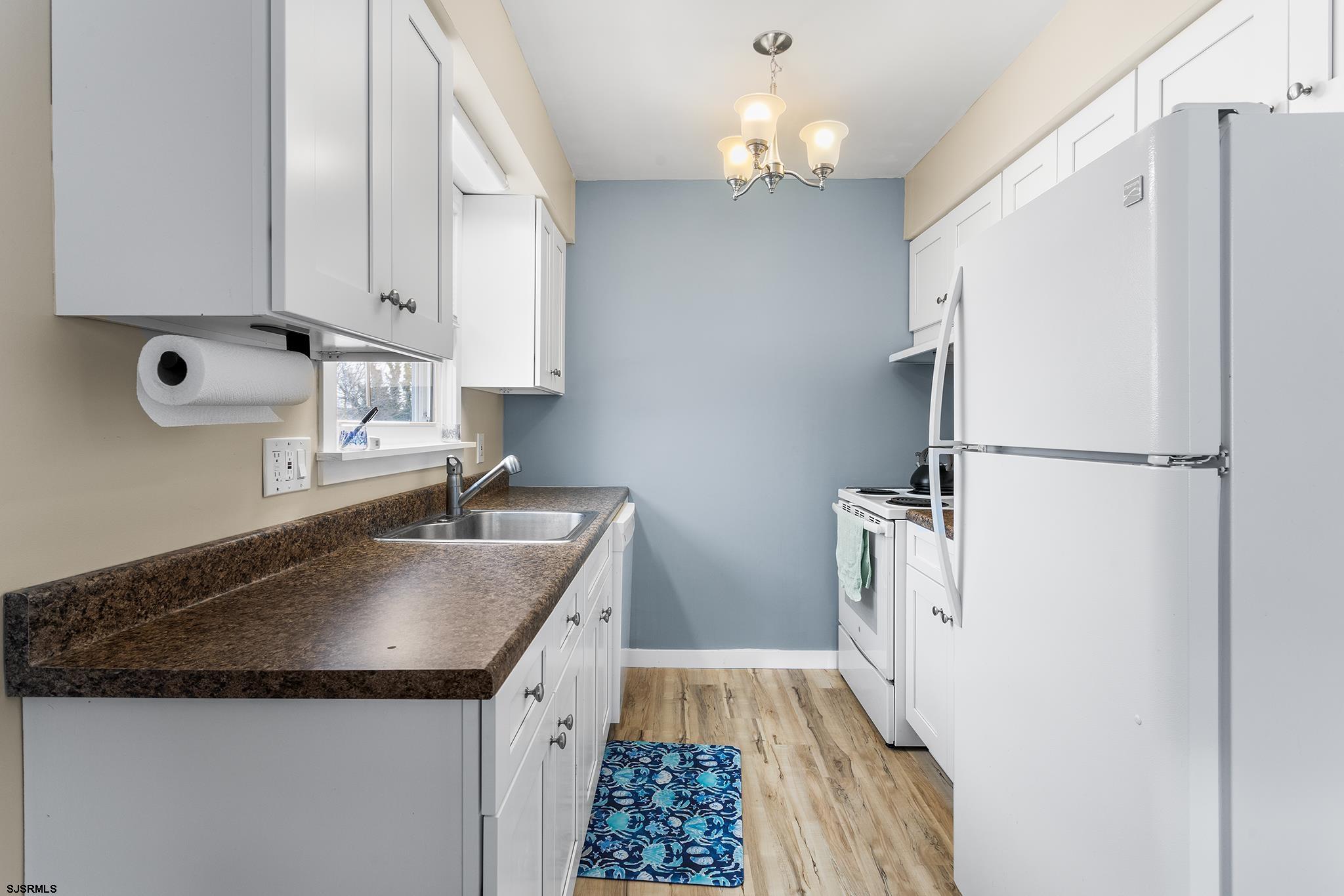 4611 Schooner Road, Unit 2 Brigantine, NJ 08203 - Photo 11 of 25 a kitchen with granite countertop a sink dishwasher a refrigerator and a stove