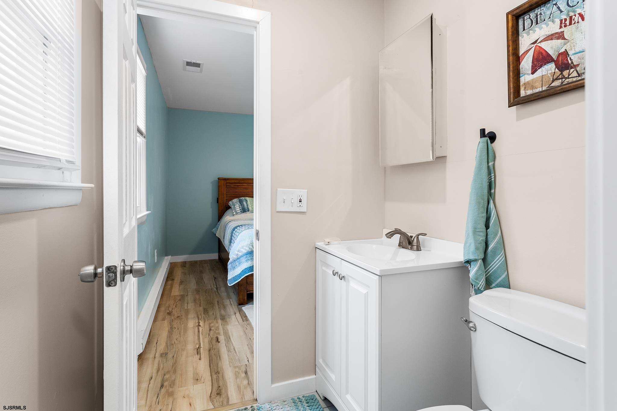 4611 Schooner Road, Unit 2 Brigantine, NJ 08203 - Photo 15 of 25 a bathroom with a sink toilet and vanity
