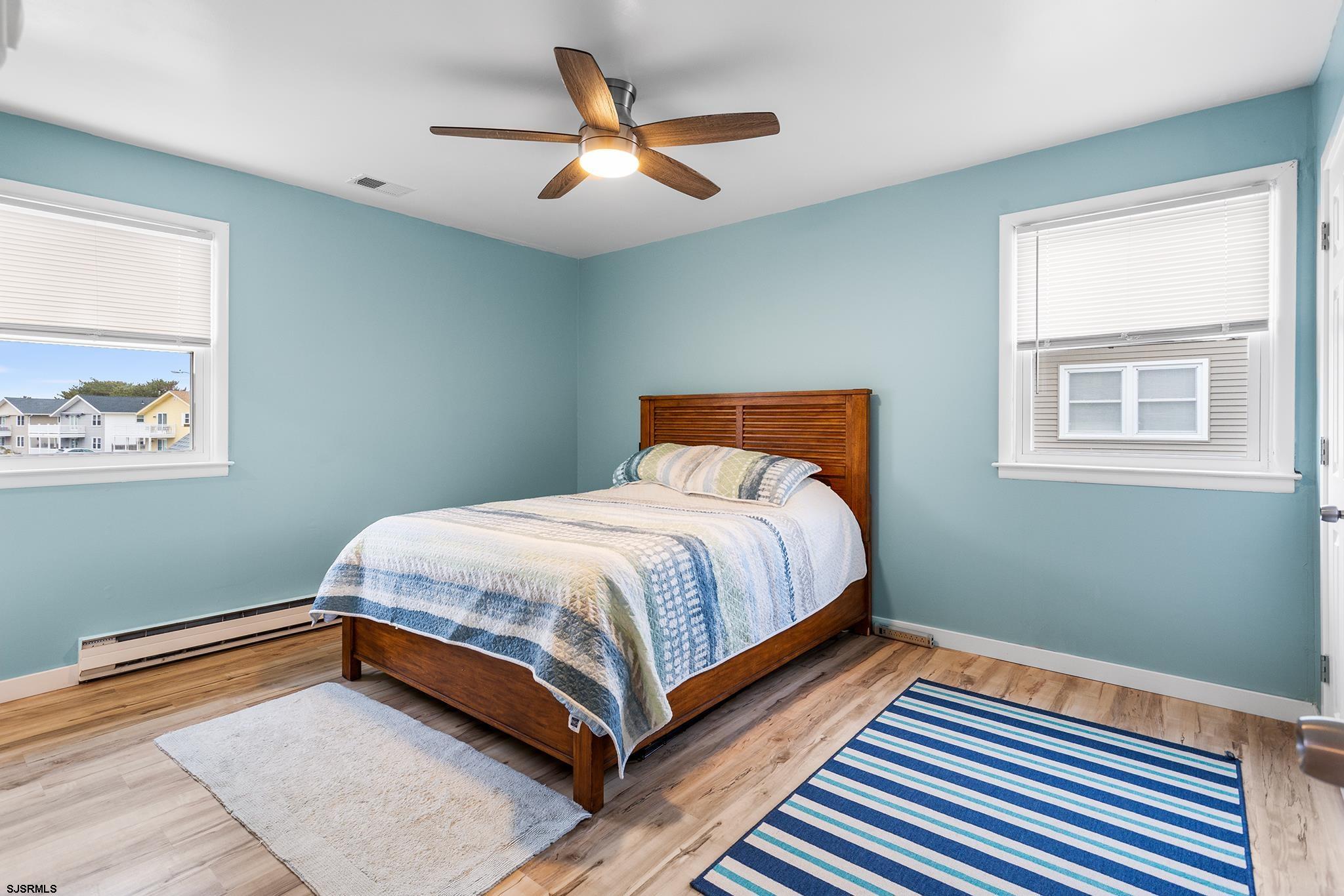 4611 Schooner Road, Unit 2 Brigantine, NJ 08203 - Photo 17 of 25 a bedroom with a bed and a painting on the wall