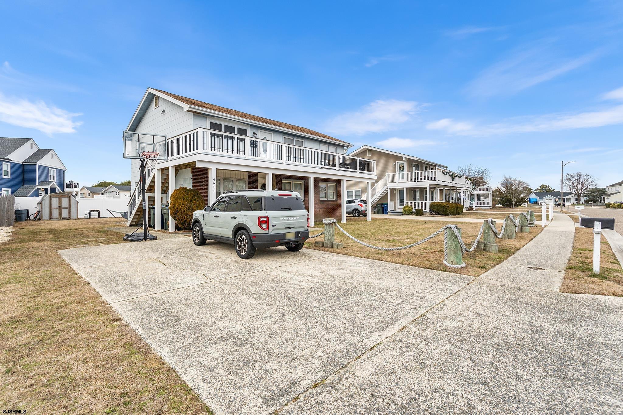 4611 Schooner Road, Unit 2 Brigantine, NJ 08203 - Photo 3 of 25 a view of a house with truck parked on the road