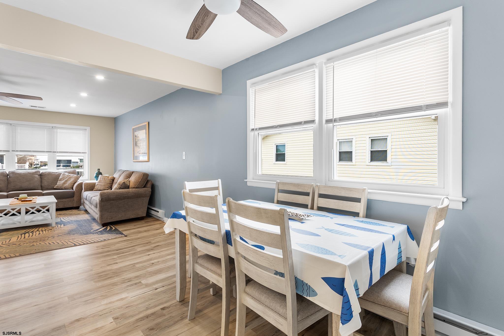 4611 Schooner Road, Unit 2 Brigantine, NJ 08203 - Photo 8 of 25 a view of a dining room with furniture window and wooden floor