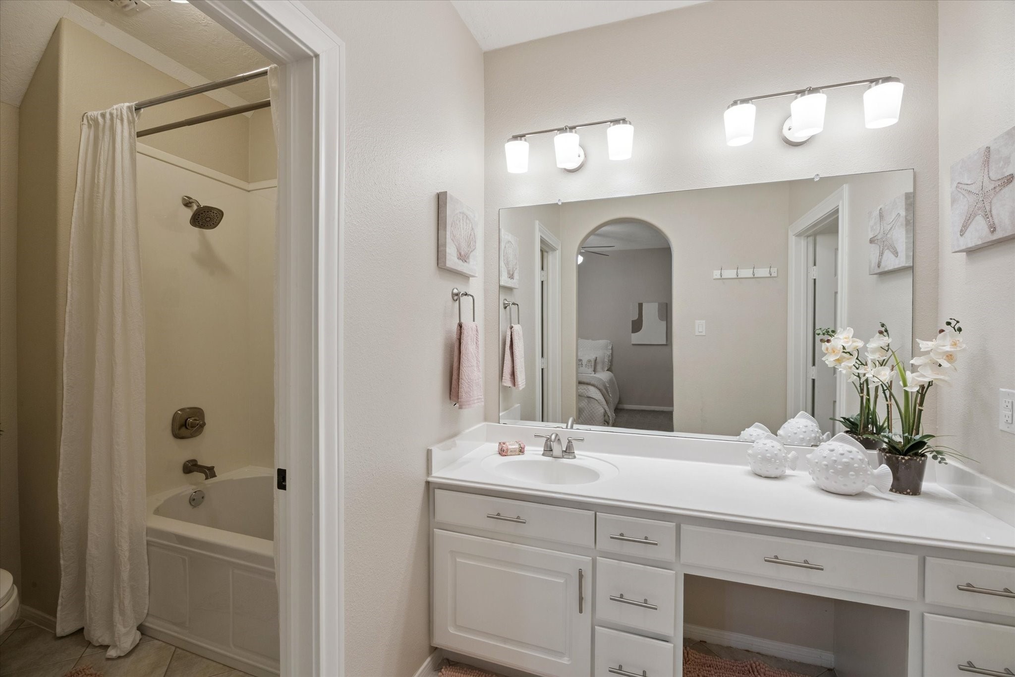 2904 Bridle Path Lane Friendswood, TX 77546 - Photo 34 of 49 The attached en-suite bathroom is bright and spacious, featuring a generous vanity area for added comfort and convenience.