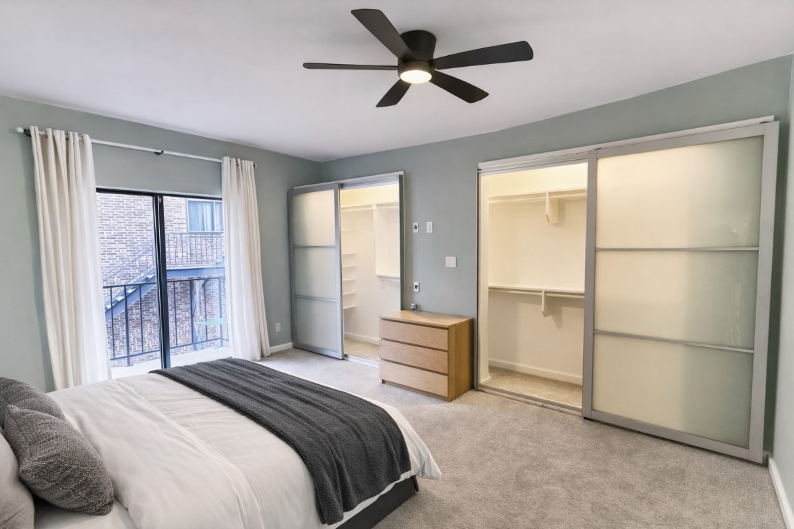 1501 Barton Springs Road, Unit 240 Austin, TX 78704 - Photo 10 of 23 Bedroom with multiple closets, carpet floors, access to outside, and a ceiling fan