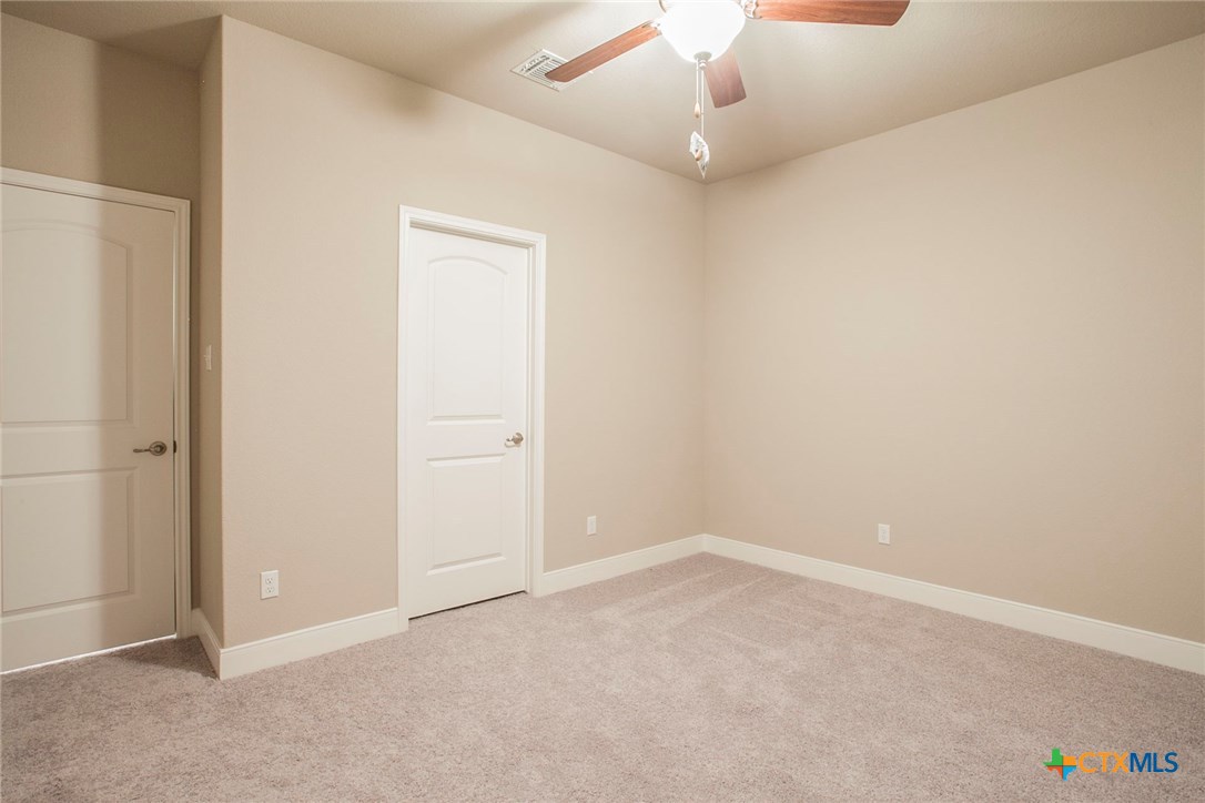 549 Wills Point Way Belton, TX 76513 - Photo 22 of 31 an empty room with a chandelier fan