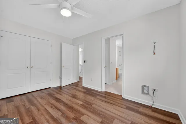 a view of an empty room with wooden floor
