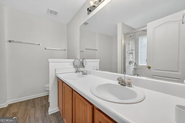 a bathroom with a sink double vanity and a mirror