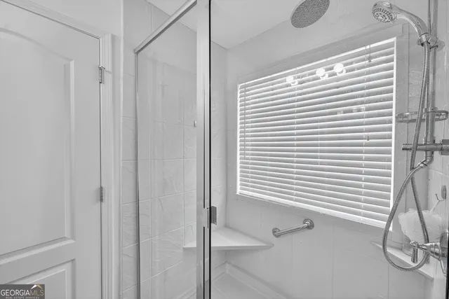 a bathroom with a shower and a curtain