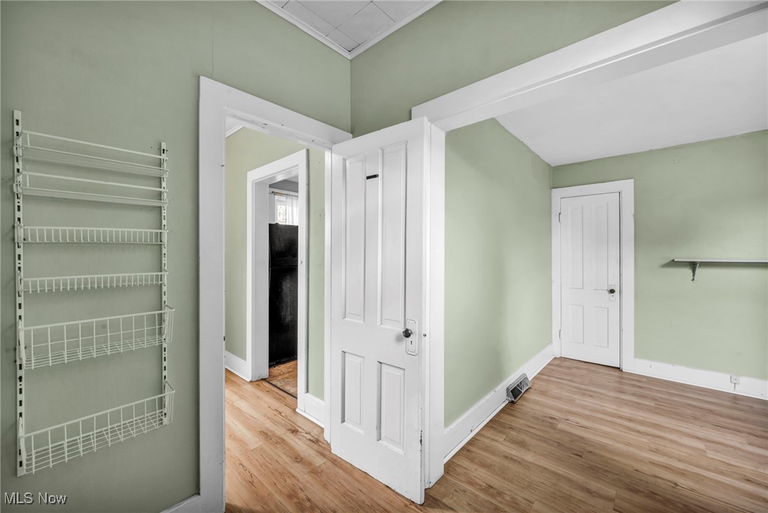 816 Perry Street Sandusky, OH 44870 - Photo 19 of 38 Corridor with wood finished floors and radiator heating unit