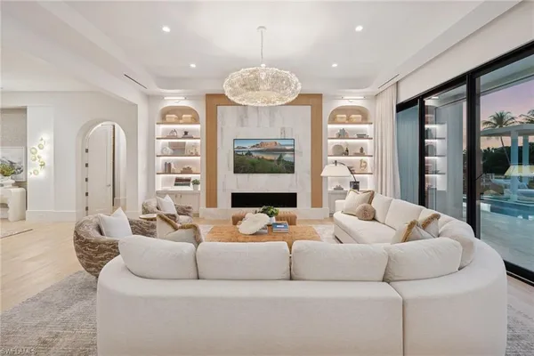 a large living room with stainless steel appliances kitchen island granite countertop furniture and a view of kitchen