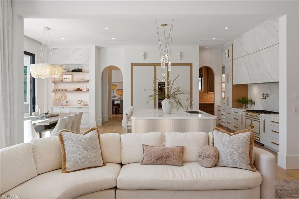1990 7th Street South Naples, FL 34102 - Photo 11 of 49 a large living room with stainless steel appliances kitchen island granite countertop furniture and a view of kitchen