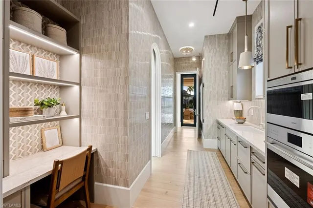 a bathroom with a granite countertop sink and a large mirror