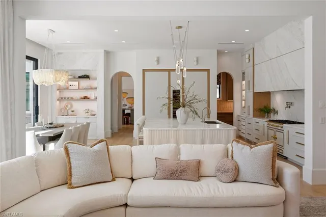 a large living room with stainless steel appliances kitchen island granite countertop furniture and a view of kitchen