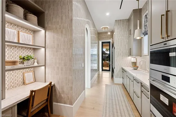 a living room with furniture and kitchen view