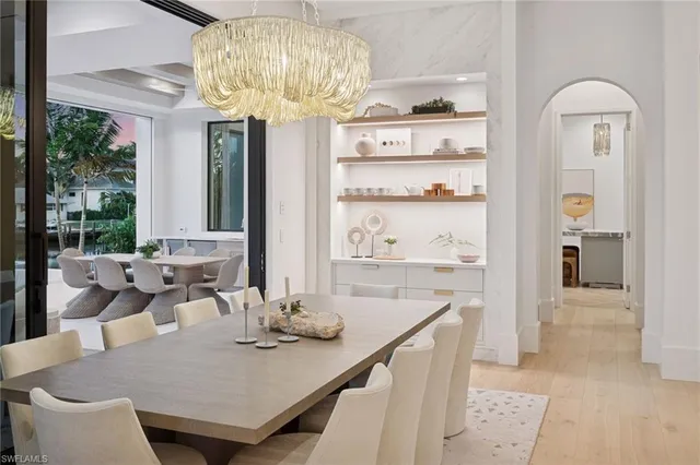 a view of a dining room with furniture kitchen and chandelier