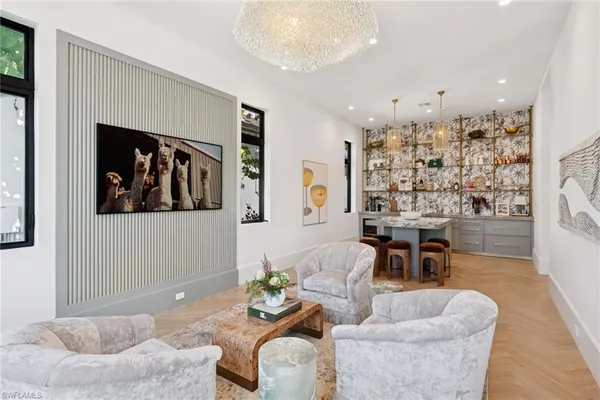 a bedroom with furniture and large windows